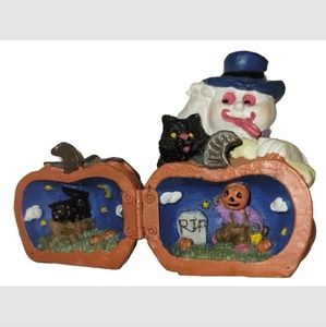 Halloween Ghost Holding a pumpkin that has a hidden cemetery scene inside